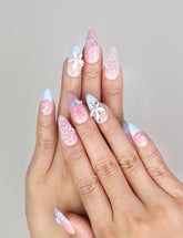 Hand model wearing Naillover Mermaid’s Floral Dream handmade press on nails in pink and blue with 3D floral accents, trendy nails Singapore.